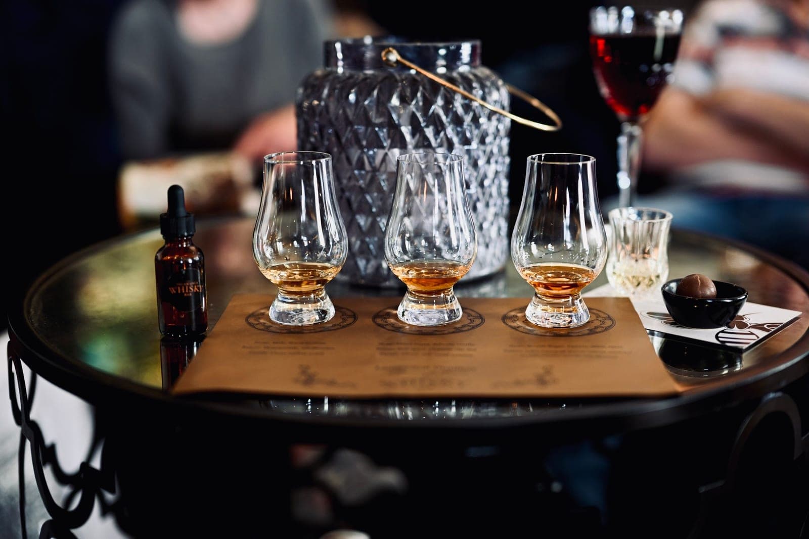 A flight of whiskey glasses set out for tasting