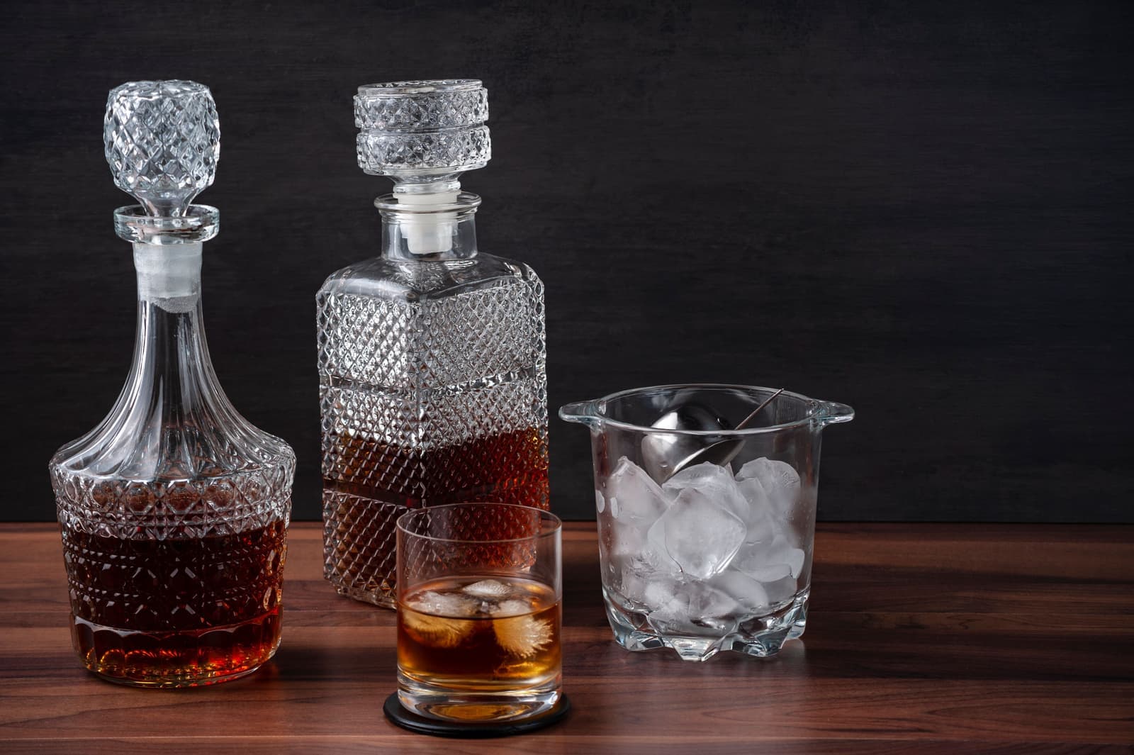 An elegant whiskey setup on a dark wooden table
