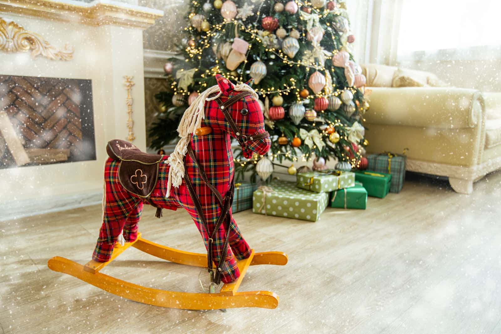 Wrapped presents under a Christmas tree in a warm living room
