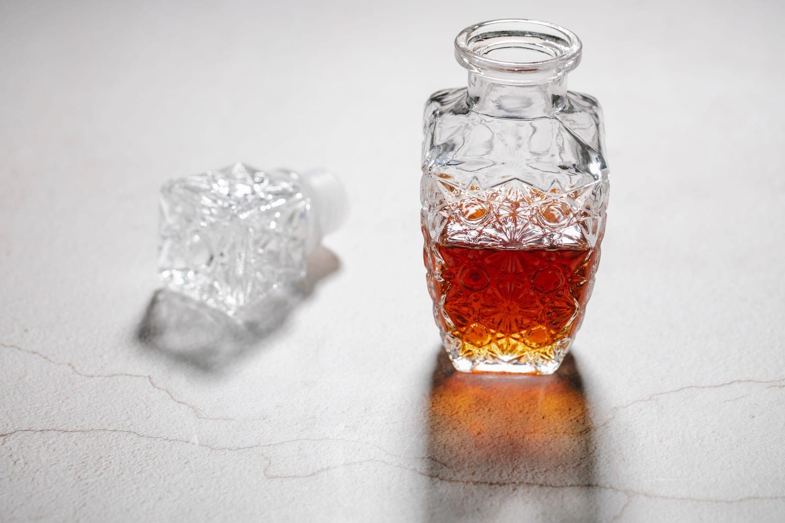 A crystal decanter holding amber spirit in warm afternoon light