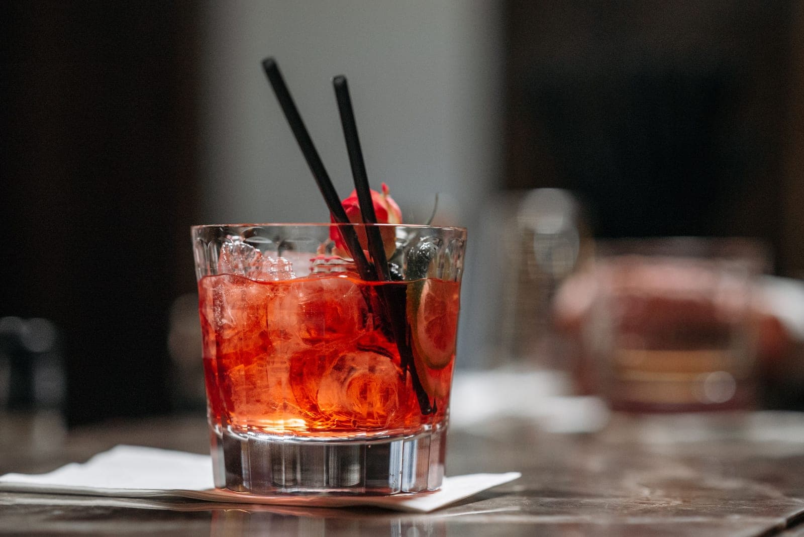 A large ice sphere in a heavy whiskey tumbler