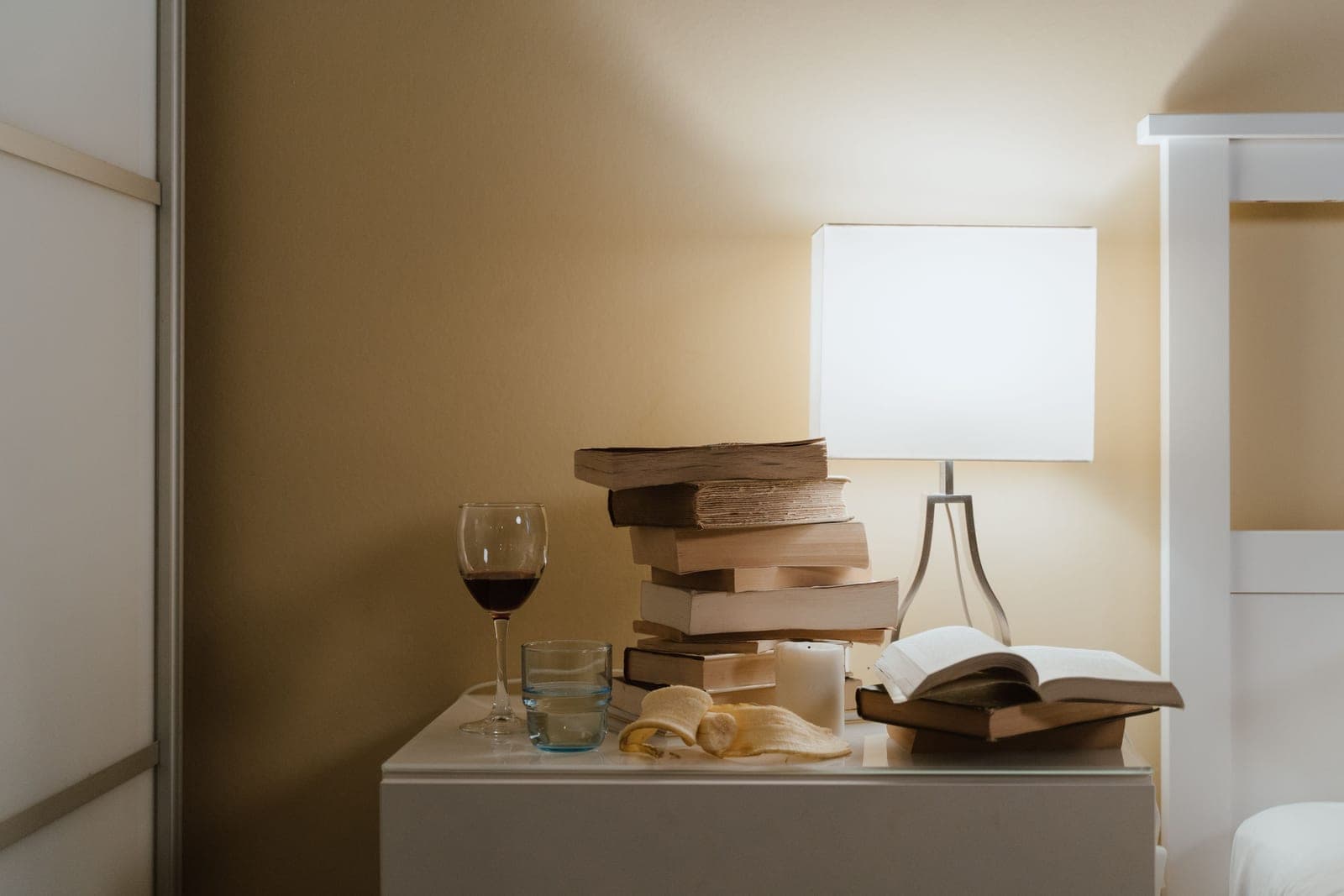 A whiskey book open beside a glass